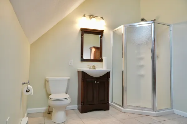 a bathroom with a toilet a sink and mirror
