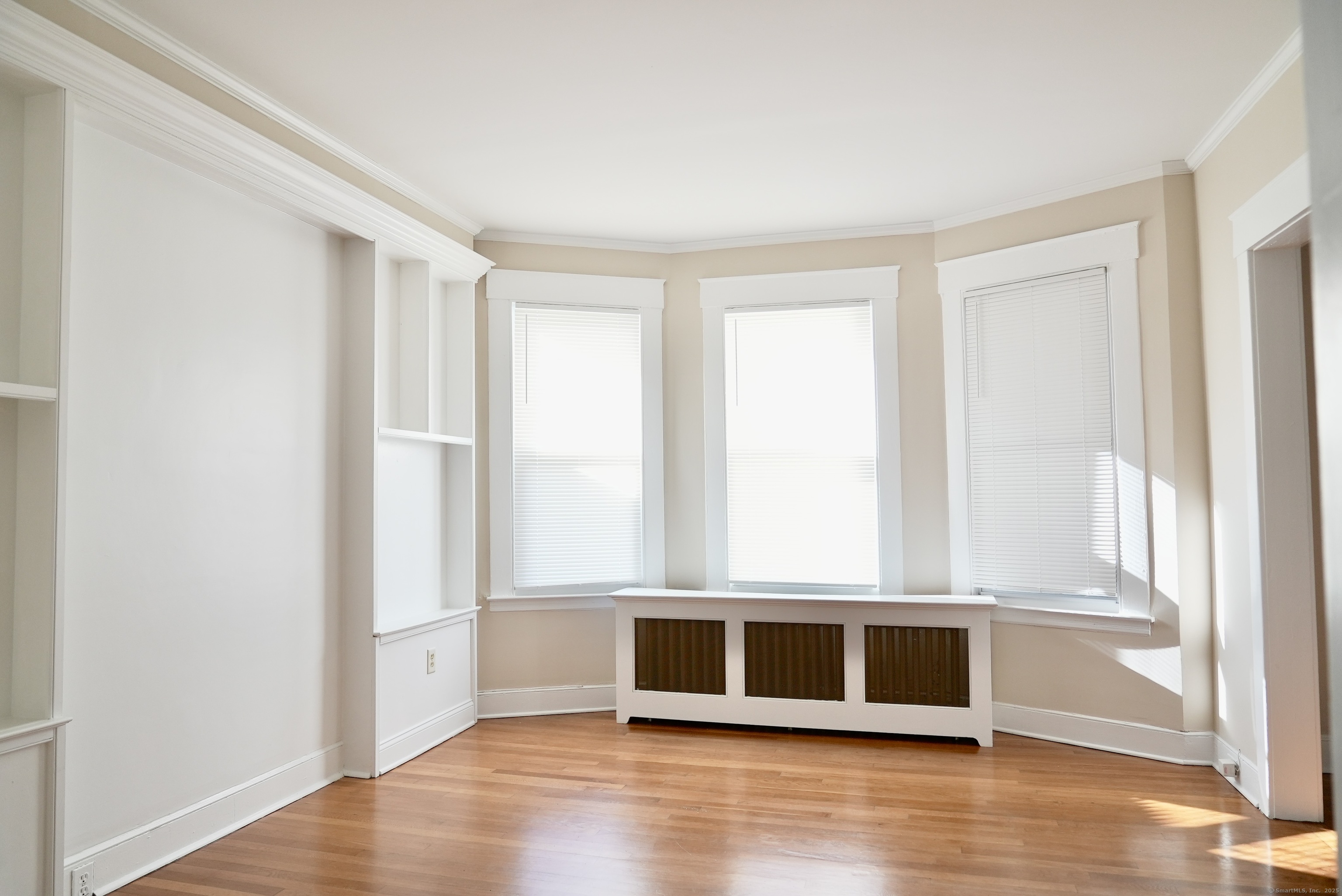 39 Pardee Place New Haven, CT 06515 - Photo 7 of 32 a view of an empty room with wooden floor and a window