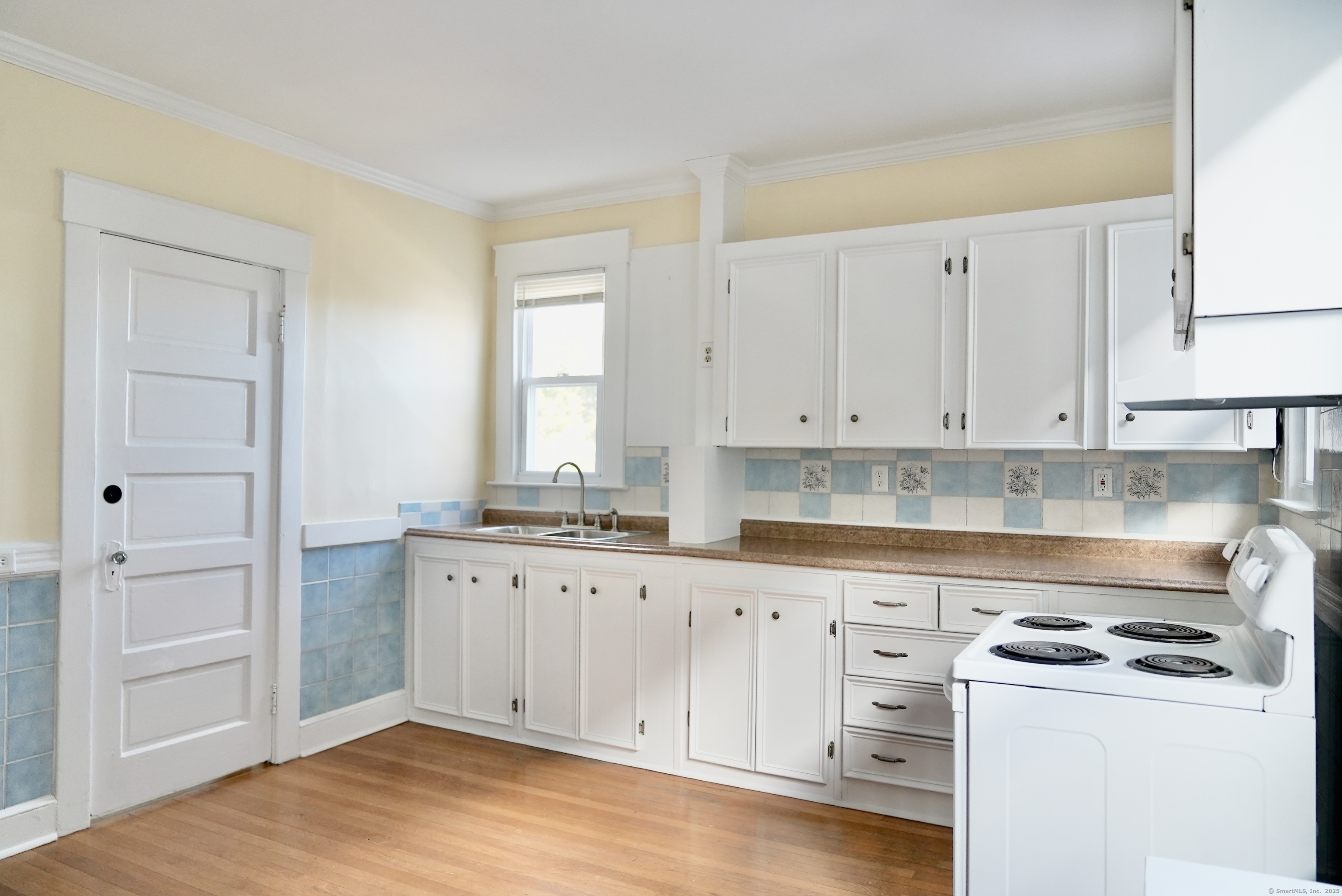 39 Pardee Place New Haven, CT 06515 - Photo 10 of 32 a kitchen with granite countertop white cabinets and white appliances