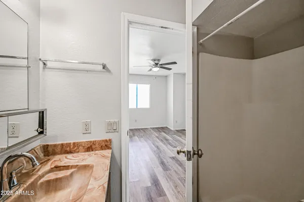 a bathroom with a tub sink and shower