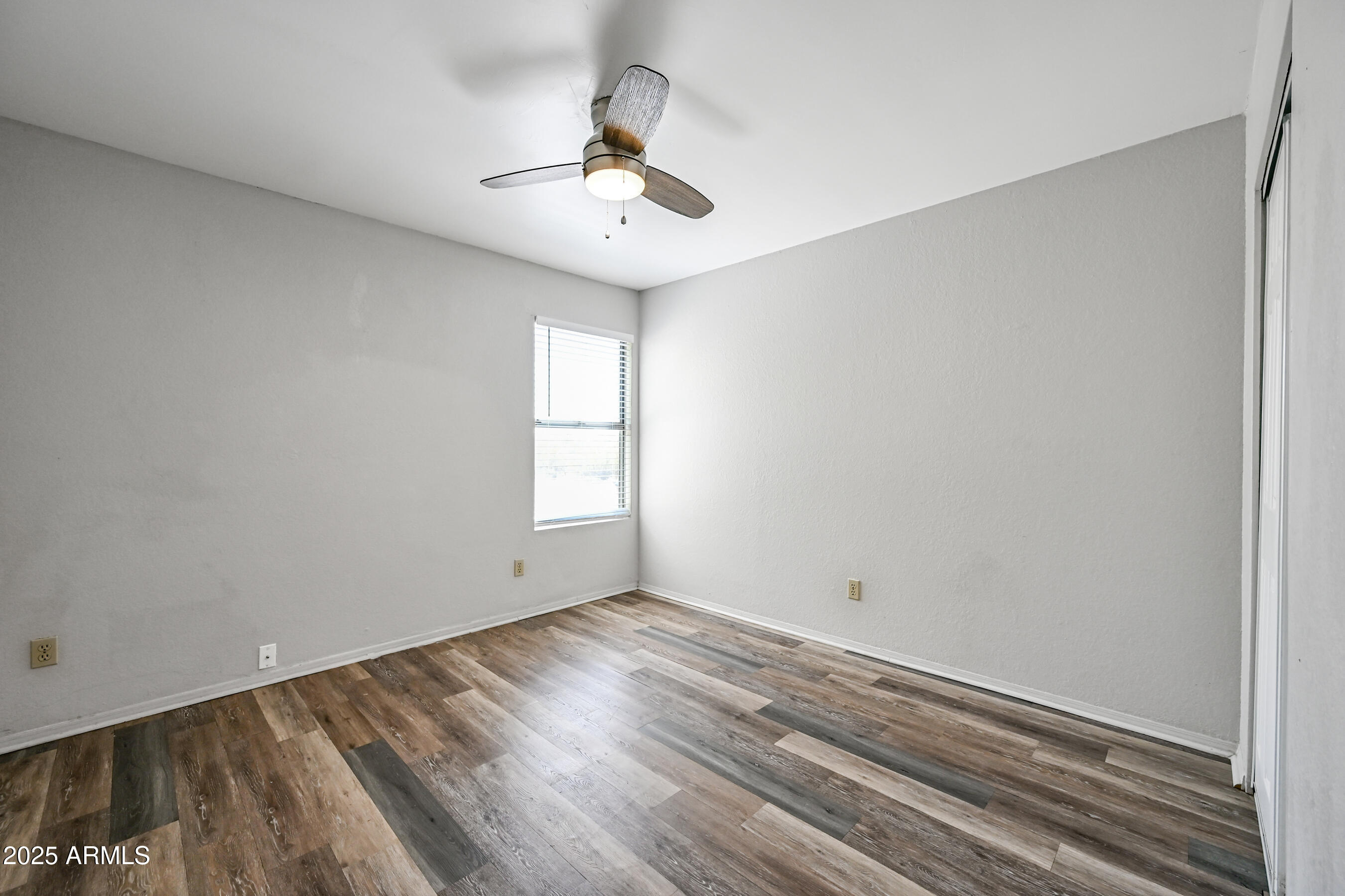 5580 South Kings Ranch Road, Unit 1 Gold Canyon, AZ 85118 - Photo 16 of 19 wooden floor in an empty room with a window
