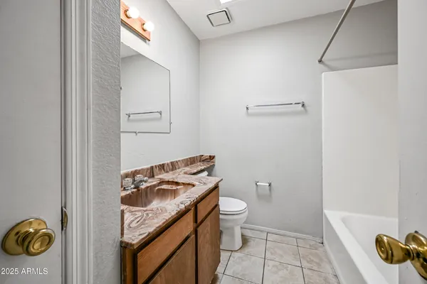 a bathroom with a toilet a sink and shower