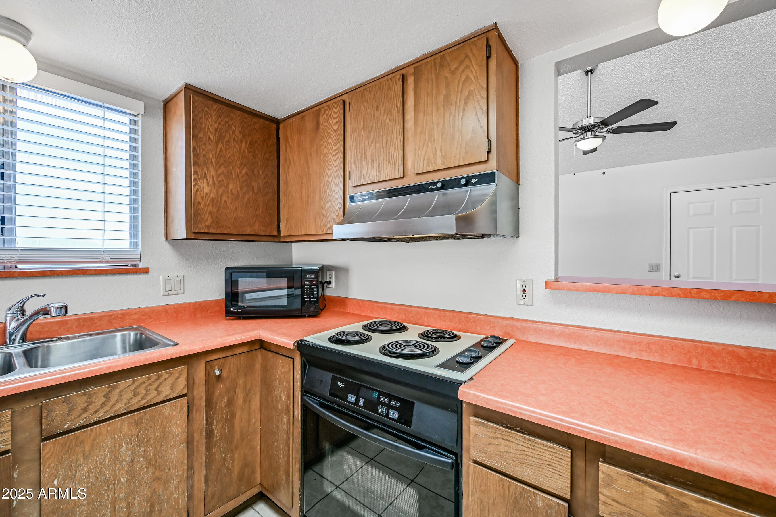 5580 South Kings Ranch Road, Unit 1 Gold Canyon, AZ 85118 - Photo 6 of 19 a kitchen with stainless steel appliances a stove a sink and cabinets