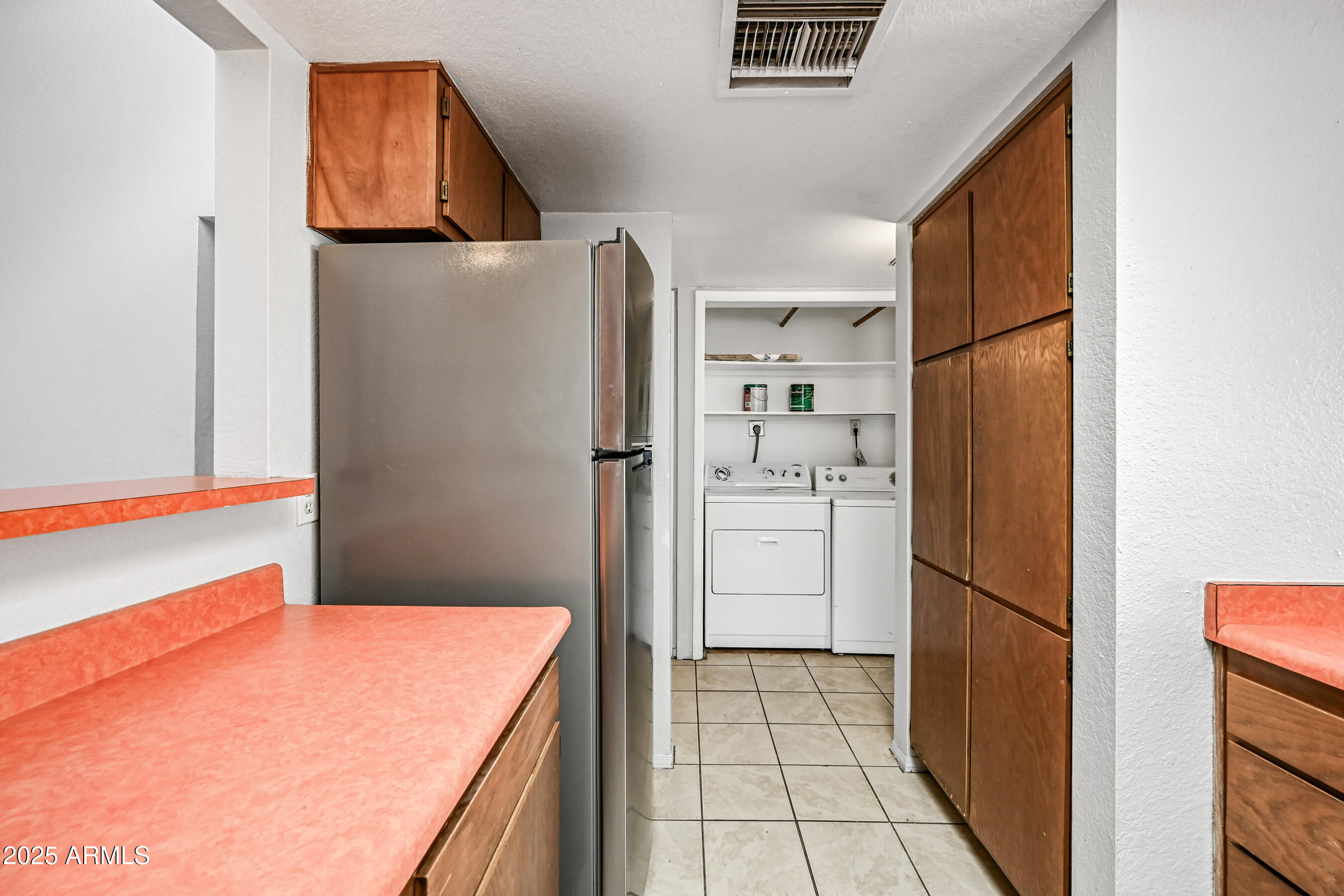 5580 South Kings Ranch Road, Unit 1 Gold Canyon, AZ 85118 - Photo 9 of 19 a kitchen with stainless steel appliances a refrigerator and a stove