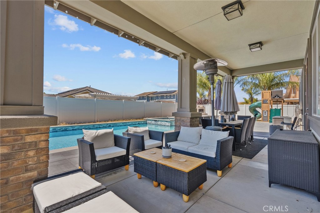 232 River Street Fillmore, CA 93015 - Photo 48 of 61 Exceptional outdoor entertaining space featuring a sparling poo, cozy firepit, ample seating areas, and a wood-burning-fireplace, perfect for or hosting gatherings year-round