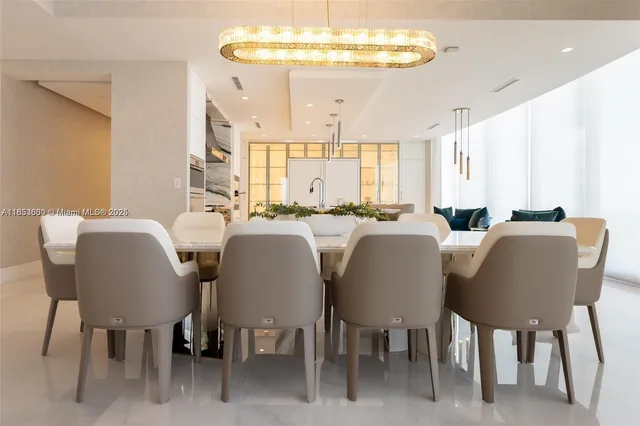 a view of a dining room with furniture and a chandelier