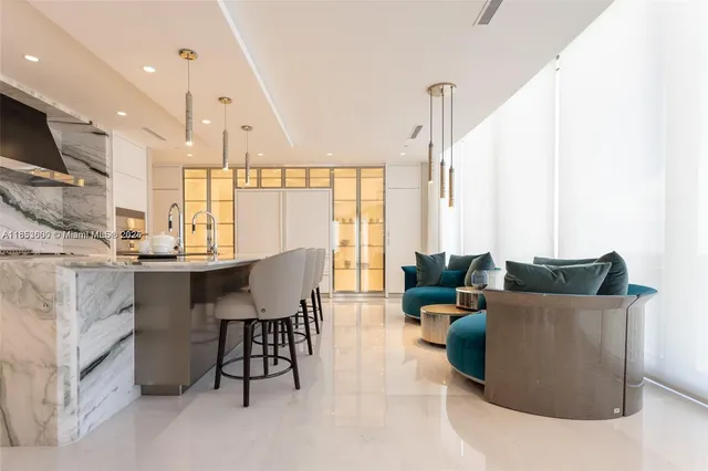 a living room with furniture kitchen view and a large window