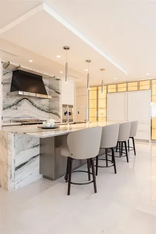 a living room with stainless steel appliances kitchen island granite countertop furniture and a kitchen view