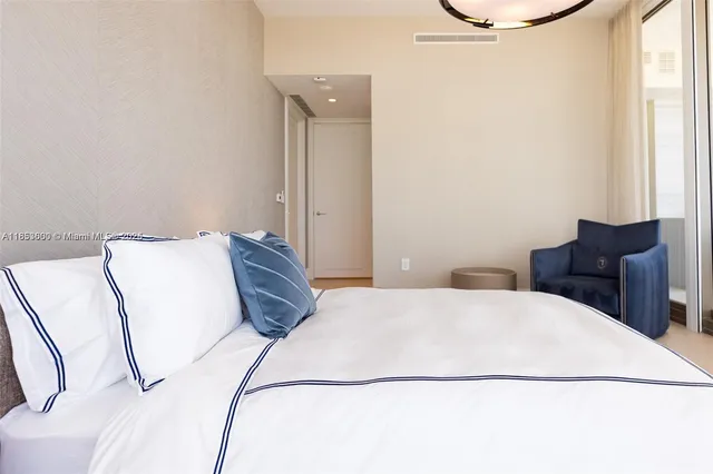 a bedroom with a bed couch and window