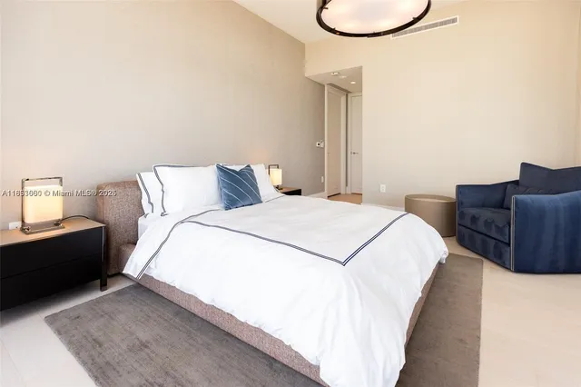 a spacious bedroom with a bed and couch