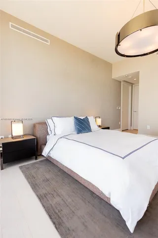 a bedroom with a bed and a chair