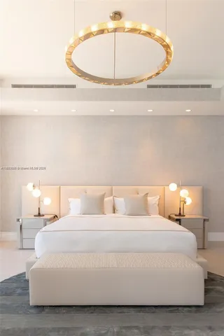 a large white bed in a white room
