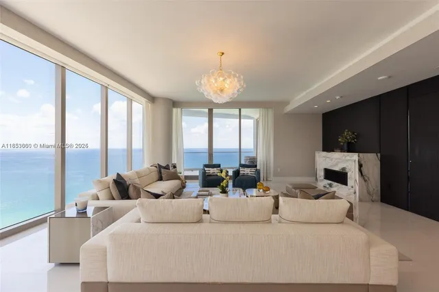 a living room with furniture and large windows