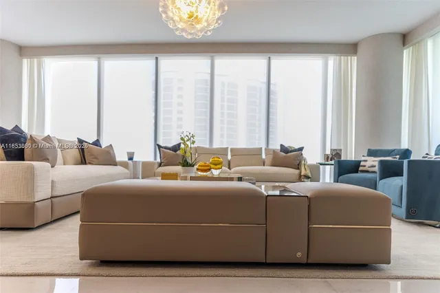 a living room with furniture and large windows