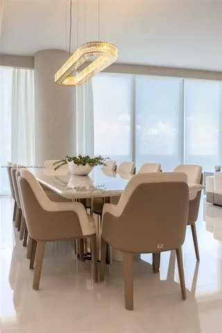 a view of a dining room with furniture and a chandelier