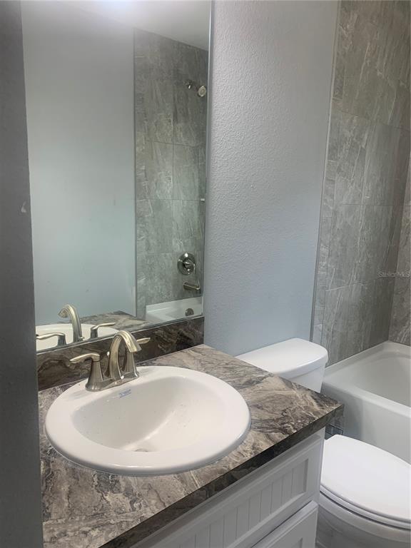 16201 Crider Road Brooksville, FL 34614 - Photo 11 of 18 a bathroom with a granite countertop sink and a mirror