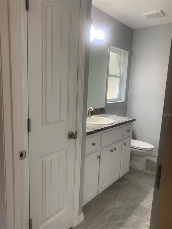 16201 Crider Road Brooksville, FL 34614 - Photo 10 of 18 a spacious bathroom with a toilet sink and mirror