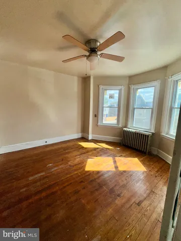 wooden floor and window in an empty room