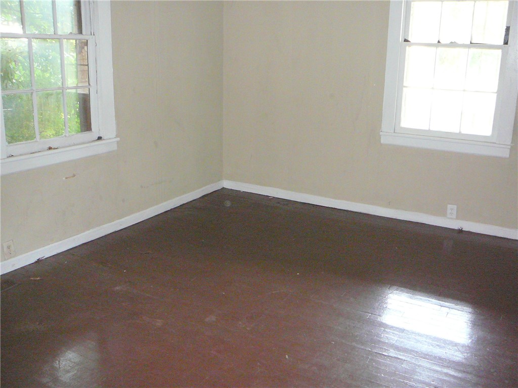 213 K Street Anderson, SC 29625 - Photo 8 of 8 Well-lit interior space with rich hardwood floors and classic window frames.