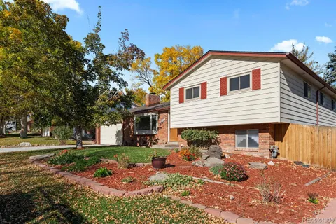 a front view of a house with a yard and outdoor seating