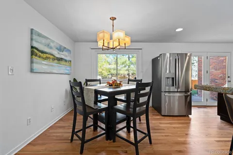 a dining room with furniture a window and wooden floor