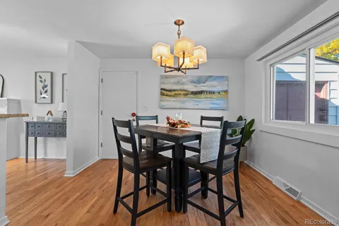 a view of a dining room with furniture wooden floor and chandelier