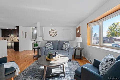 a living room with furniture and wooden floor