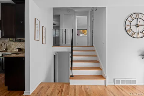a view of entryway and hall with wooden floor
