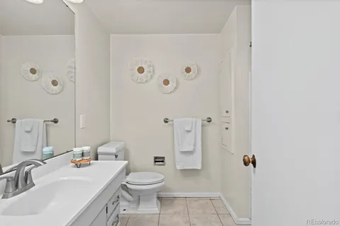 a bathroom with a sink a toilet and shower curtain