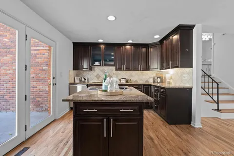 a kitchen with counter top space a sink cabinets and appliances