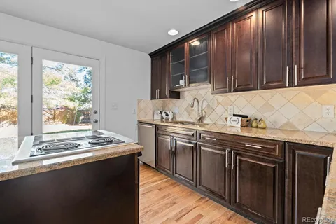 a kitchen with stainless steel appliances granite countertop a sink stove and cabinets