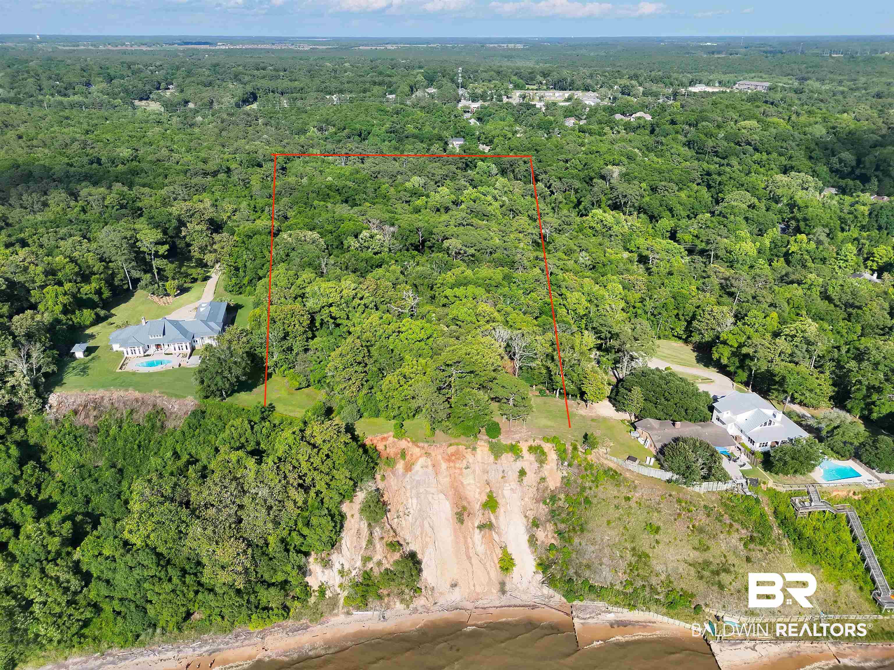 22951 Main Street Fairhope, AL 36532 - Photo 1 of 13 Aerial overview of property's location featuring property parcel outlined and a forest