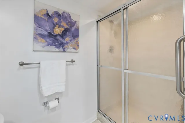 a bathroom with a painting on the wall and shower