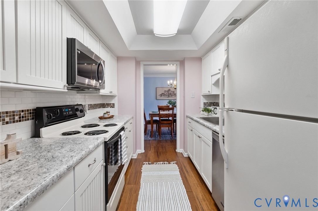 2956 Hathaway Road, Unit 903 Richmond, VA 23225 - Photo 3 of 27 a kitchen with stainless steel appliances granite countertop a stove a sink and a refrigerator