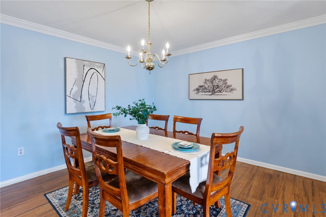2956 Hathaway Road, Unit 903 Richmond, VA 23225 - Photo 7 of 27 a dining room with furniture a chandelier and wooden floor