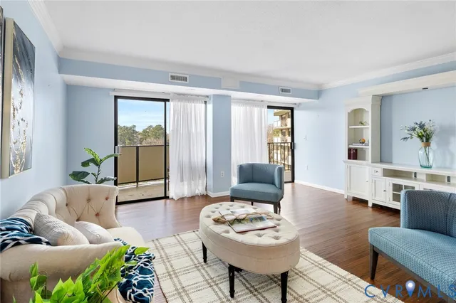a living room with furniture and wooden floor
