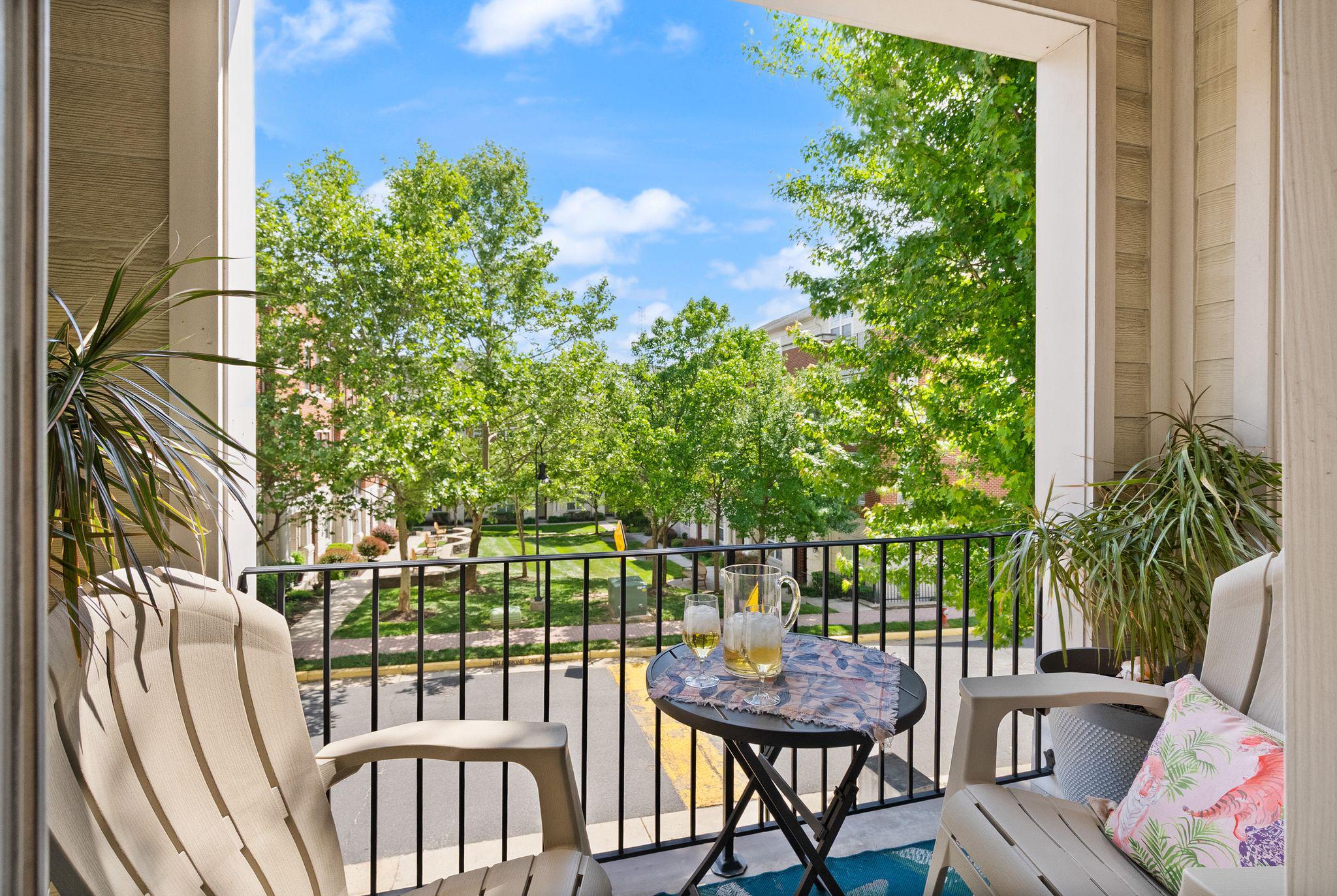a view of a chairs and table in the balcony