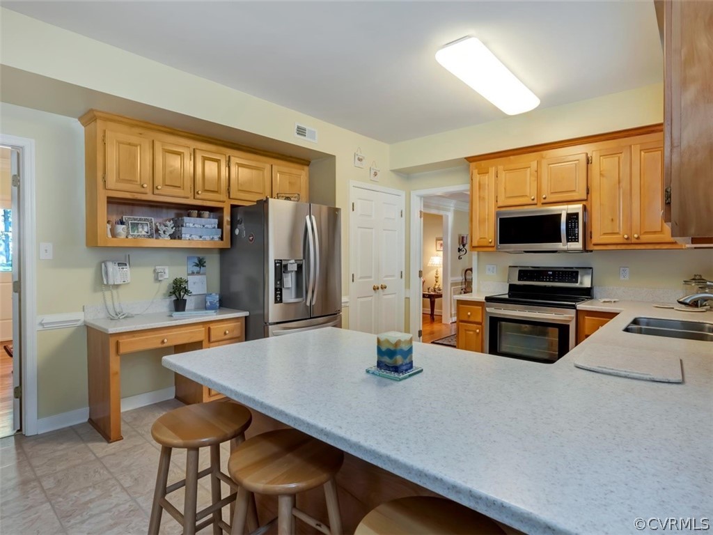 15211 Powell Grove Road Midlothian, VA 23112 - Photo 11 of 34 a kitchen with a stove a sink and a refrigerator