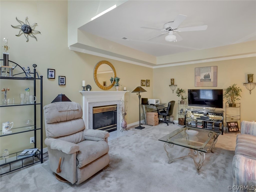 15211 Powell Grove Road Midlothian, VA 23112 - Photo 13 of 34 a living room with furniture a flat screen tv and a fireplace
