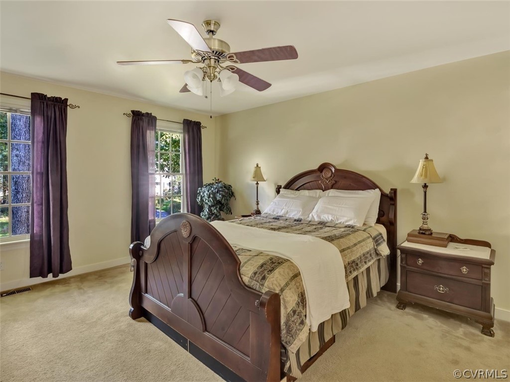 15211 Powell Grove Road Midlothian, VA 23112 - Photo 21 of 34 a bedroom with a bed and a chandelier