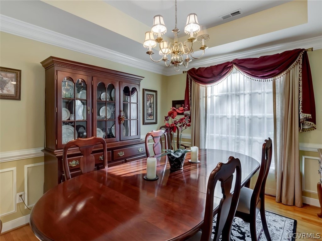 15211 Powell Grove Road Midlothian, VA 23112 - Photo 7 of 34 a view of a dining room with furniture wooden floor and chandelier