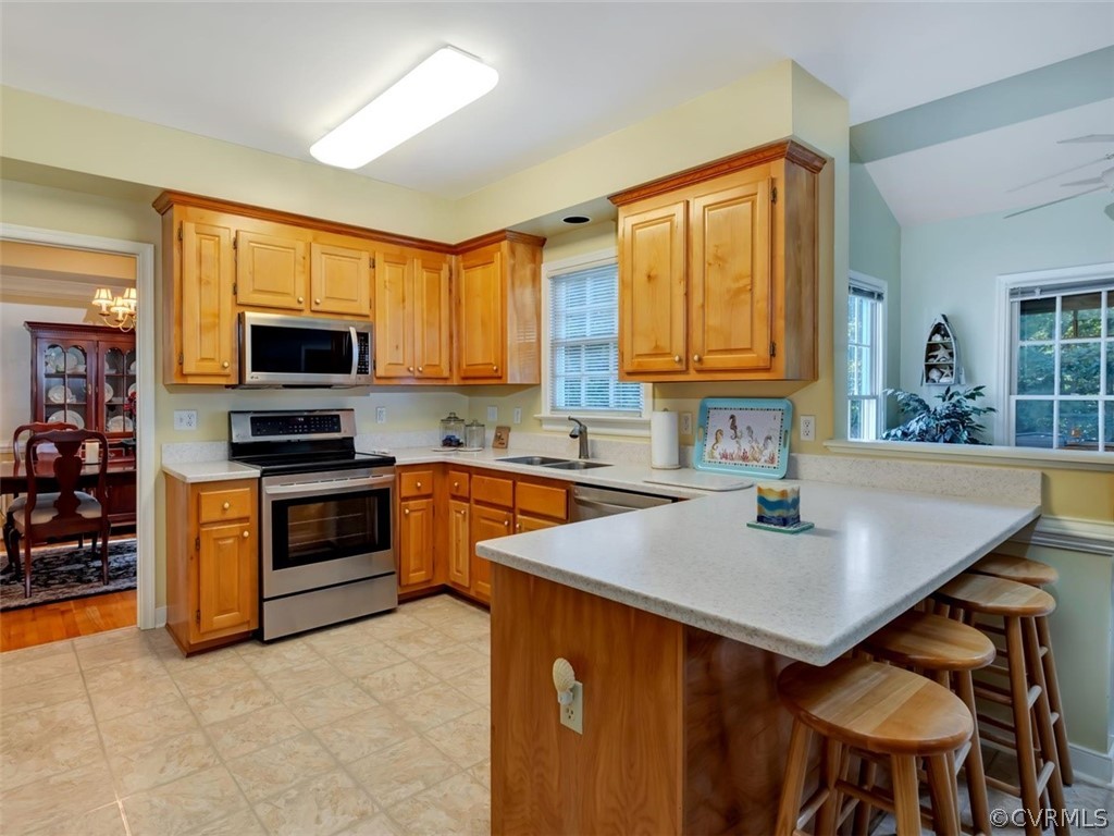 15211 Powell Grove Road Midlothian, VA 23112 - Photo 10 of 34 a kitchen with stainless steel appliances granite countertop a sink a stove counter space and a window