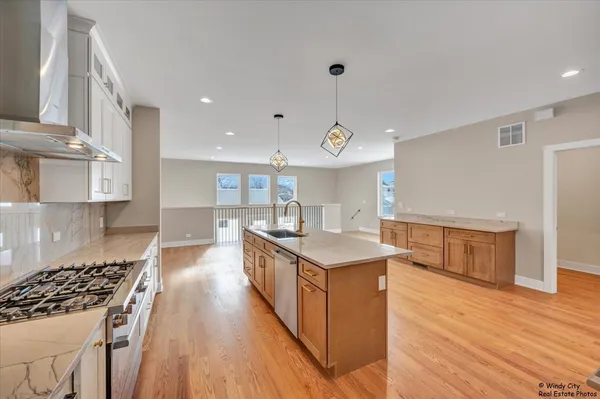 a kitchen with a stove and a wooden floor
