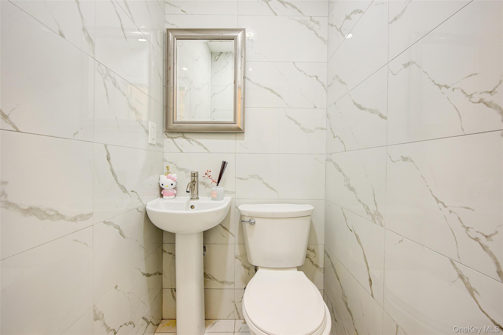 164-38 76th Road Queens, NY 11366 - Photo 13 of 44 a bathroom with a sink mirror and toilet