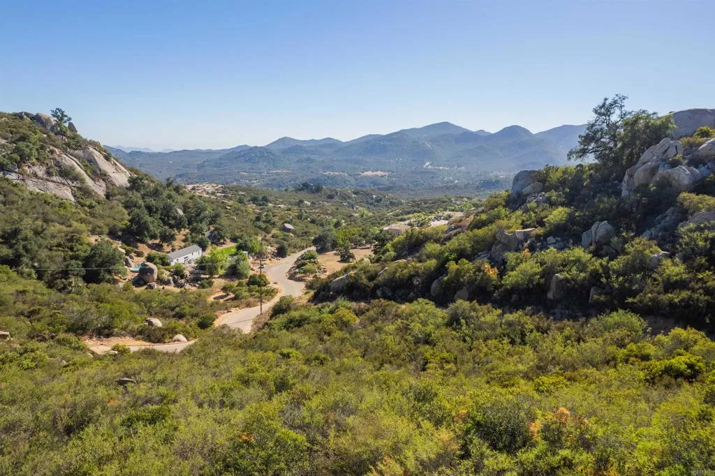 Mahogany Ranch Ramona, CA 92065 - Photo 32 of 39 a view of a lush green field with mountains in the background