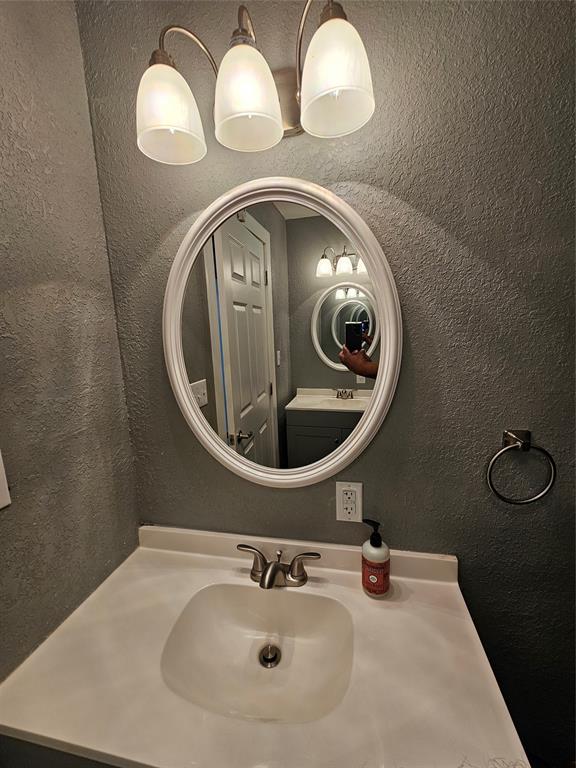165 Elmwood Road Whitney, TX 76692 - Photo 20 of 28 Bathroom with vanity and a textured wall