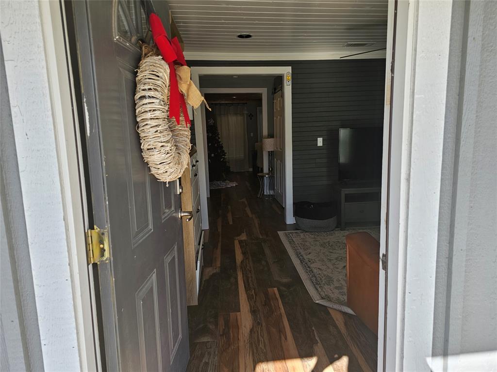 165 Elmwood Road Whitney, TX 76692 - Photo 7 of 28 Hallway featuring dark wood-style flooring