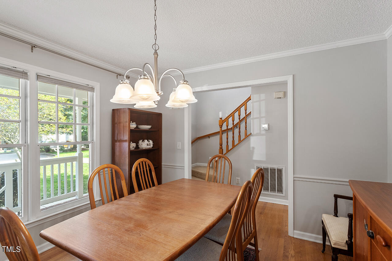 2108 Cedarbluff Court Raleigh, NC 27615 - Photo 16 of 38 a view of a dining room with furniture window and wooden floor
