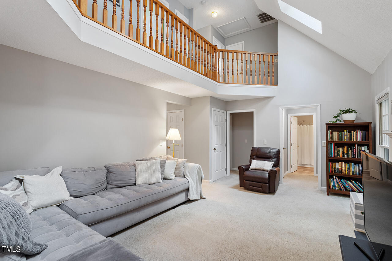 2108 Cedarbluff Court Raleigh, NC 27615 - Photo 2 of 38 a living room with furniture a book shelf and a couch