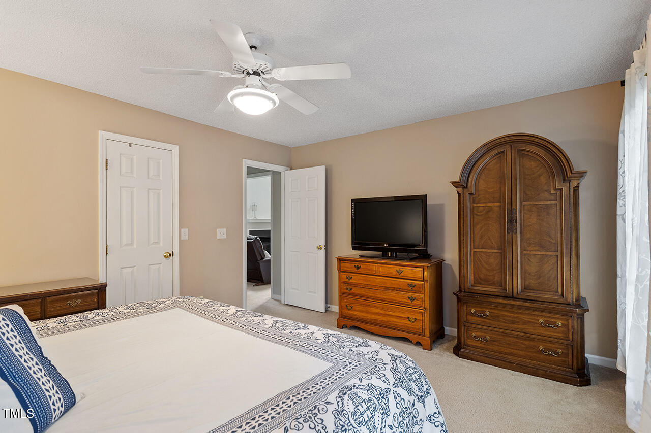 2108 Cedarbluff Court Raleigh, NC 27615 - Photo 20 of 38 a bedroom with a bed and a flat screen tv